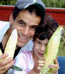 Dan and Leylee (aged 4) shuck corn